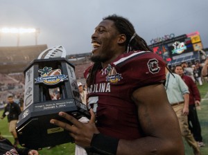  South Carolina Gamecocks defensive end Jadeveon Clowney (7) holds the Capital One Bowl trophy after defeating the Wisconsin Badgers at the game held at the Florida Citrus Bowl. Mandatory Credit: Rob Foldy-USA TODAY Sports