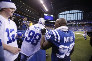 Indianapolis Colts linebacker Robert Mathis (98) autographs a fans jersey as he walks off the field after the game against the Jacksonville Jaguars at Lucas Oil Stadium. Indianapolis defeats Jacksonville 30-10. Mandatory Credit: Brian Spurlock-USA TODAY Sports