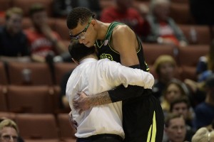 Baylor Bears center Isaiah Austin (21, right) hugs head coach Scott Drew (left) during the second half in the semifinals of the west regional of the 2014 NCAA Mens Basketball Championship tournament against the Wisconsin Badgers at Honda Center. The Badgers defeated the Bears 69-52. Mandatory Credit: Richard Mackson-USA TODAY Sports