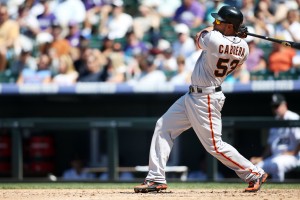 August 5, 2012; Denver, CO, USA; San Francisco Giants left fielder Melky Cabrera (53) hits a single during the fifth inning against the Colorado Rockies at Coors Field.  Credit: Chris Humphreys-US PRESSWIRE