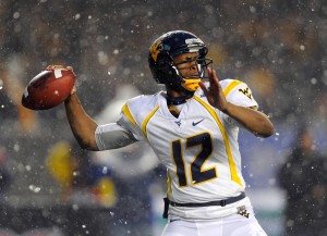 West Virginia Mountaineers QB Geno Smith (12) drops back to pass during the second quarter against the Syracuse Orange at the 2012 New Era Pinstripe Bowl at Yankee Stadium. Credit: Rich Barnes-USA TODAY Sports