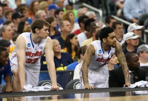 Florida Gators forward/center Erik Murphy (33) and Mike Rosario (3) react on the bench in the first half against the Michigan Wolverines during the South regional final of the 2013 NCAA Tournament at Cowboys Stadium. Mandatory Credit: Matthew Emmons-USA TODAY Sports