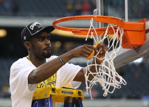Michigan Wolverines guard Tim Hardaway Jr. (10) celebrates as he cuts the net after their victory over the Florida Gators 79-59 in the South regional final of the 2013 NCAA Tournament at Cowboys Stadium. Mandatory Credit: Matthew Emmons-USA TODAY Sports