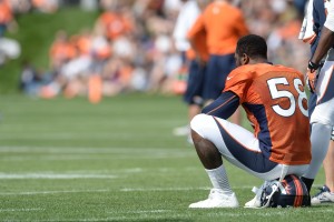 Denver Broncos outside linebacker Von Miller (58) sits on his helmet during training camp at the Broncos training facility. Mandatory Credit: Ron Chenoy-USA TODAY Sports