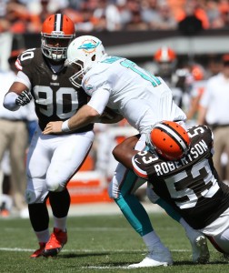 Cleveland Browns linebacker Craig Robertson (53) sacks Miami Dolphins quarterback Ryan Tannehill (17) as Cleveland Browns defensive tackle Billy Winn (90) closes in during the first quarter at FirstEnergy Field. Mandatory Credit: Ron Schwane-USA TODAY Sports