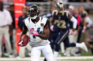 Jacksonville Jaguars wide receiver Justin Blackmon (14) carries the ball for a touchdown during the first quarter against the St. Louis Rams at The Edward Jones Dome. Mandatory Credit: Scott Kane-USA TODAY Sports