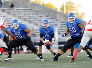 Sep 14, 2013; Buffalo, NY, USA; Buffalo Bulls quarterback Joe Licata (16) takes a snap as offensive linesman Jasen Carlson (56) and offensive linesman Andre Davis (50) block during the game against the Stony Brook Seawolves at University of Buffalo Stadium. Buffalo beats Stony Brook 26-23 in OT. Mandatory Credit: Kevin Hoffman-USA TODAY Sports