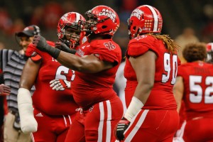  Louisiana-Lafayette Ragin Cajuns defensive lineman Christian Ringo (9) celebrates after a sack with teammates defensive lineman Justin Hamilton (6) and defensive tackle Jacoby Briscoe (90) during the second half of the New Orleans Bowl against the Nevada Wolf Pack at the Mercedes-Benz Superdome. Louisiana-Lafayette defeated Neveda 16-3. Mandatory Credit: Derick E. Hingle-USA TODAY Sports